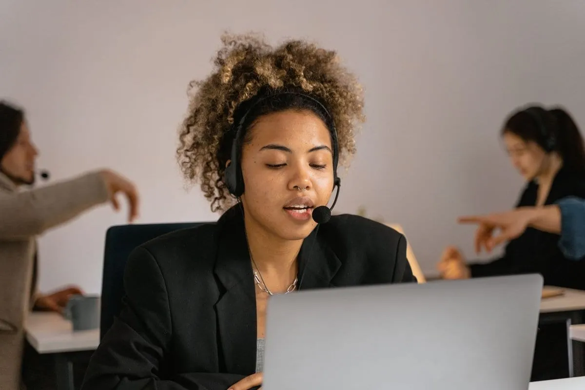 A back-office team member wearing a headset at her desk