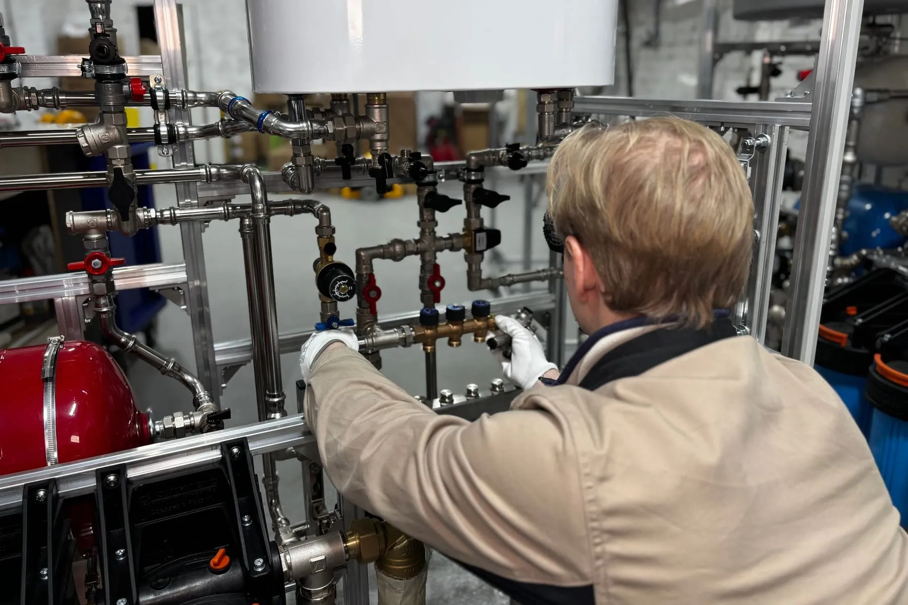 Heating engineer working on a pipe system