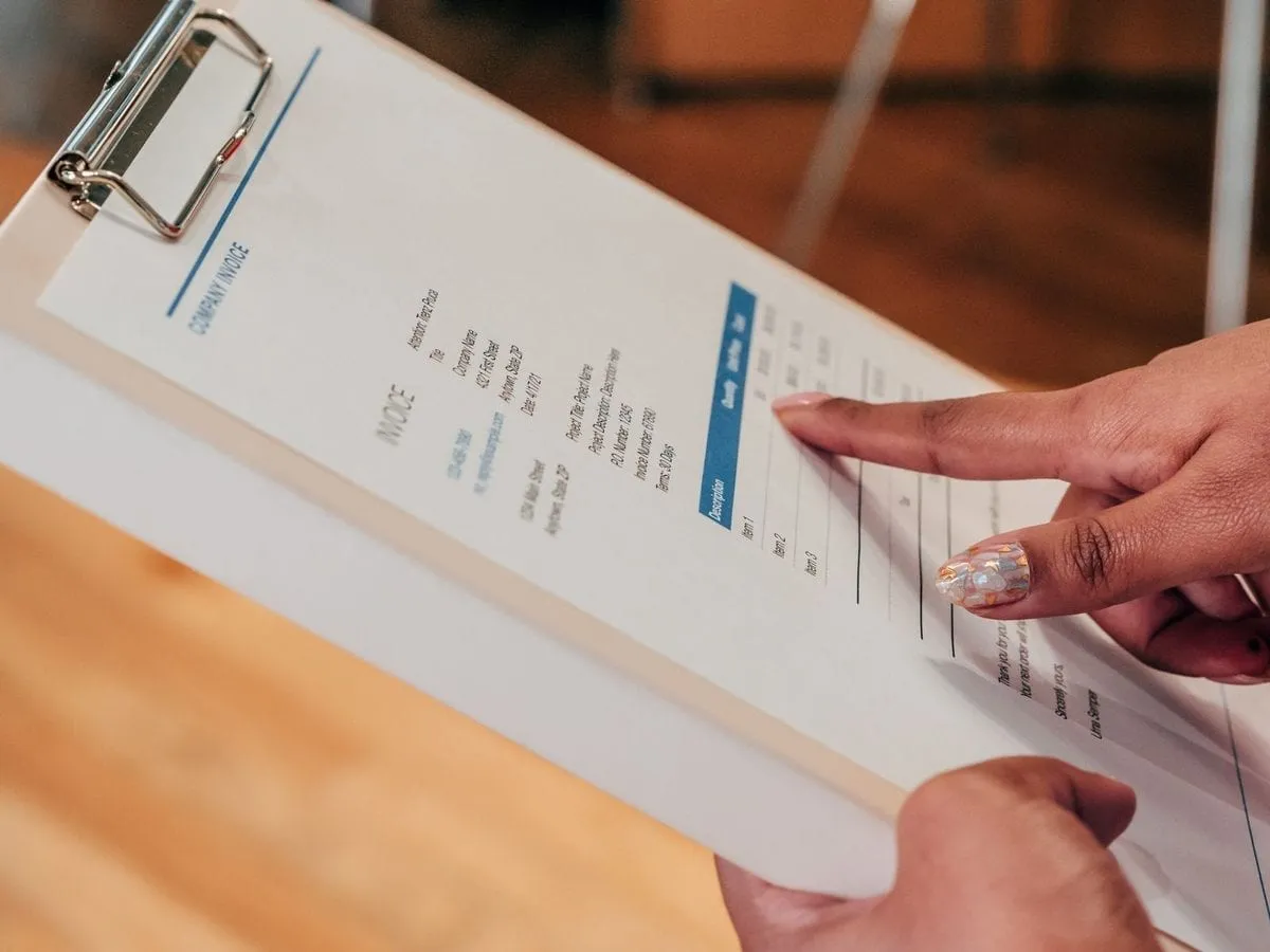 A desk with an invoice and paperwork being prepared
