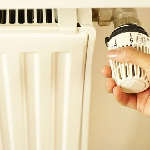 A gas engineer working on a boiler